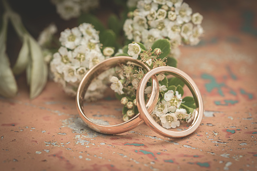 Wedding rings in gold on a rusty table. .