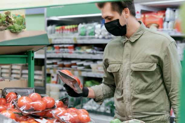 istock A man in a protective mask selects products in a supermarket 1225092905