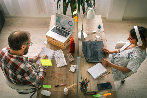 istock Business colleagues working at office with glass partition between desk 1225093024