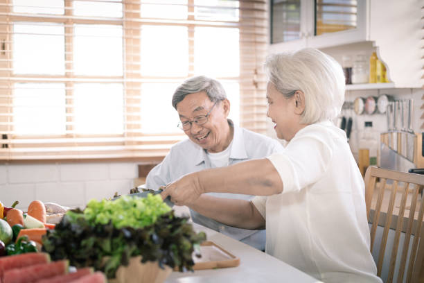 istock Senior asian couple cooking together in kitchen 1225095338