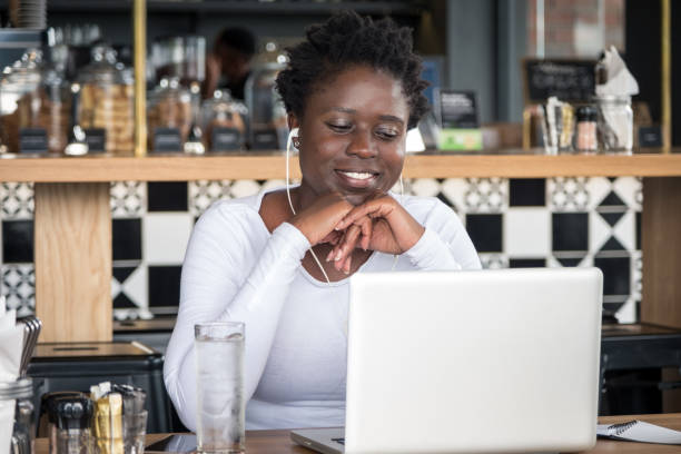 コーヒーショップでラップトップを持つ若い笑顔のアフリカの女性 - 3656 ストックフォトと画像