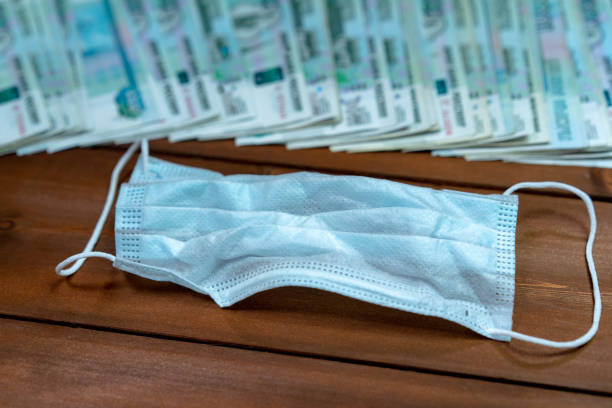 istock A bundle of money and a protective mask 1225095702