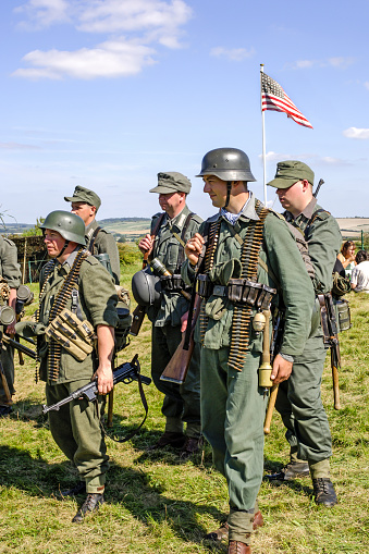 Men in a re-enactment group dressed as German Army Infantry at Maiden Newton in Dorset, UK