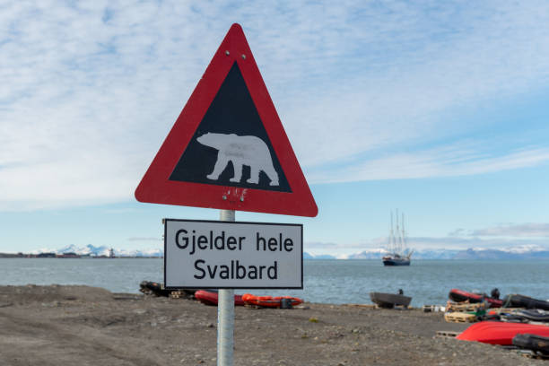 Attention - polar bear warning signs in Longyearbyen, Svalbard archipelago, Norway (Translations for non-English text: "Applies to all of Svalbard" stock photo