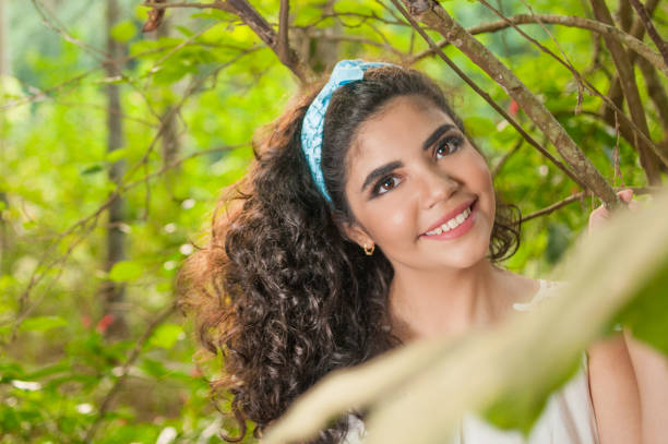 istock Pretty girl in nature looking at the camera  with a peaceful expression. 1225100143