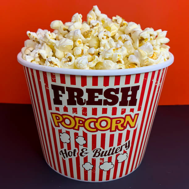 istock Close up delicious fresh buttery popcorn in a stripped red and white bowl 1225101478