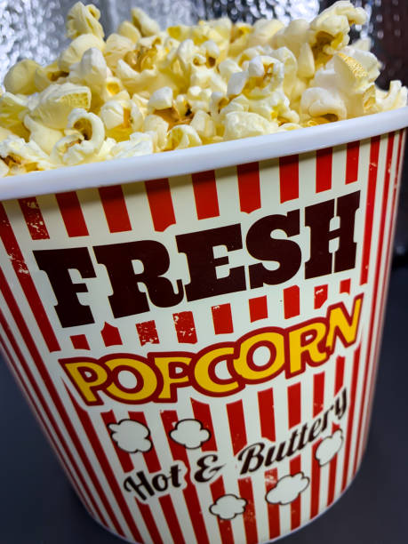 istock Close up delicious fresh buttery popcorn in a stripped red and white bowl 1225101489