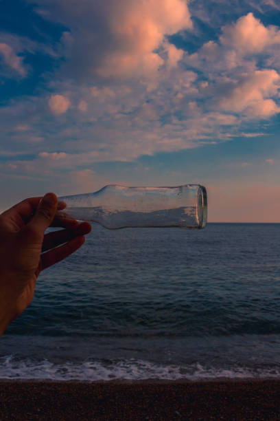 istock A man holding a clear glass bottle 1225104080