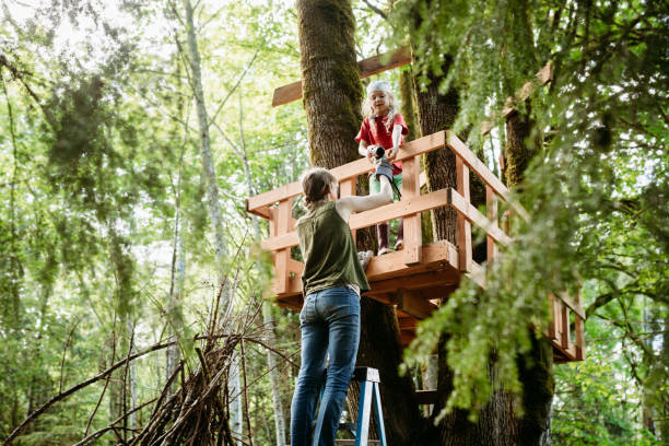 istock Mother And Daughter Work in Backyard Tree Fort 1225106003