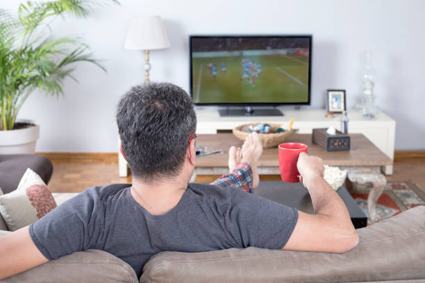 istock man watching sport on tv 1225106642