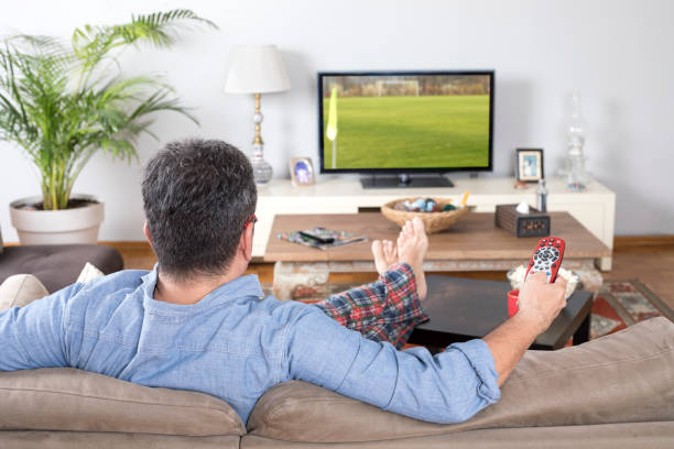 istock man watching sport on tv 1225106644