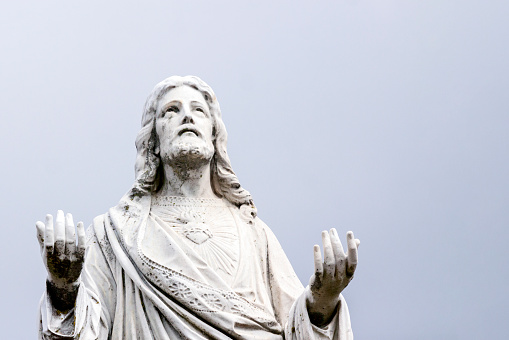 Old statue of Jesus Christ, cemetery build in 1877 Australia, background with copy space, horizontal composition