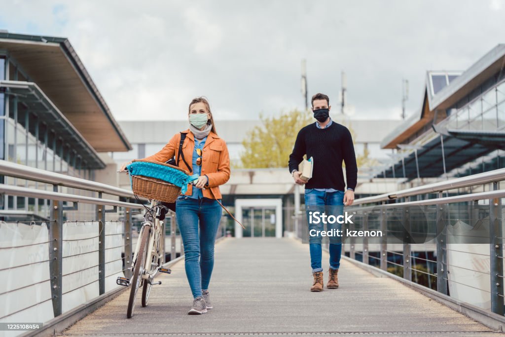 Students on university campus wearing masks during coronavirus crisis Students on university campus wearing masks during coronavirus crisis keeping social distance Protective Face Mask Stock Photo