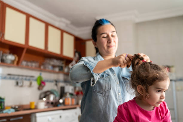 istock Mother Combing Daughter's Hair Indoor 1225111512