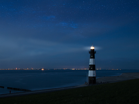 Lighthouse at night with stars in Netherlands, Zeeland, Breskens
