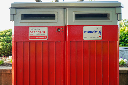 Red mailbox at Lake Te Anau, Lake Te Anau and Town street scene, Fiordland, New Zealand.