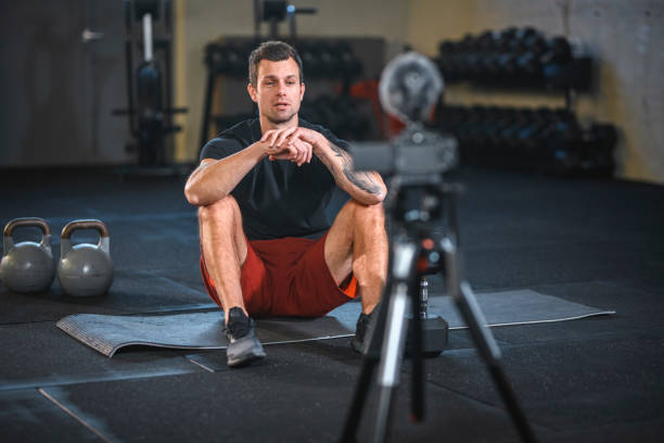 istock Fitness Instructor Creating Vlog about Lifting Kettlebells 1225115522