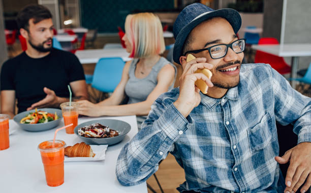 istock Cheerful modern man having phone conversation in cafe 1225115725