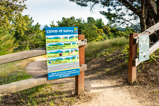 Please stay on trail sign next to path in Rocky Mountains