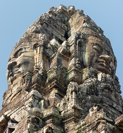 Siem Reap, Cambodia - January 22, 2020: Bayon is a late 12th-century Mahayana Buddhist temple. The Bayon's most distinctive feature is the multitude of serene and smiling stone faces.