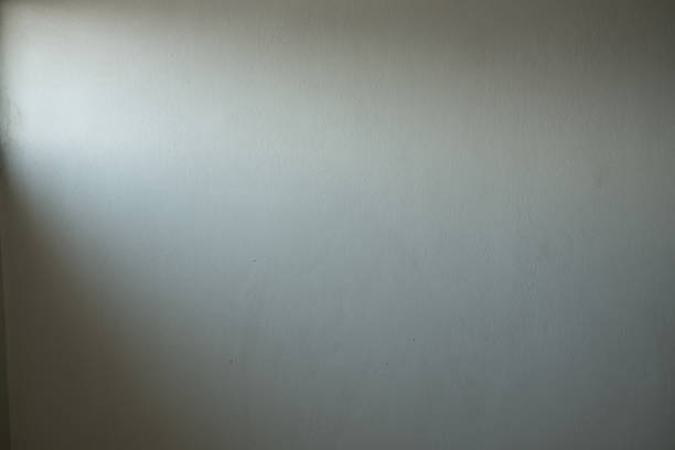 istock Old white concrete wall texture And the light that shines through the window 1225124082