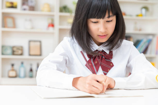 girl in a uniform who study asian girl in a uniform who study child japanese culture japan asian ethnicity stock pictures, royalty-free photos & images