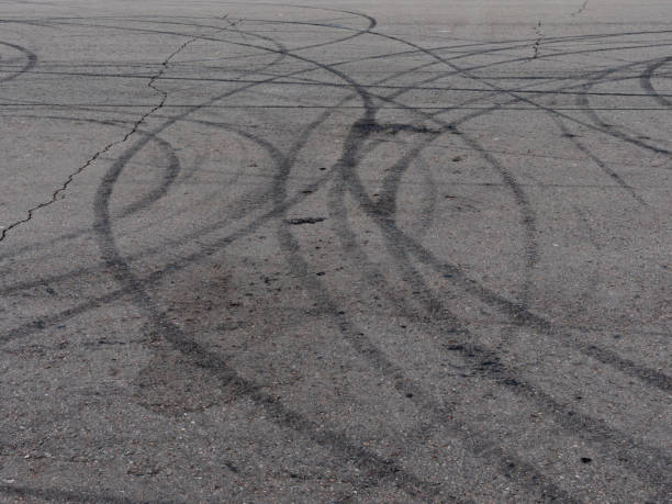 istock Black trail from rubber tires on the asphalt 1225129497