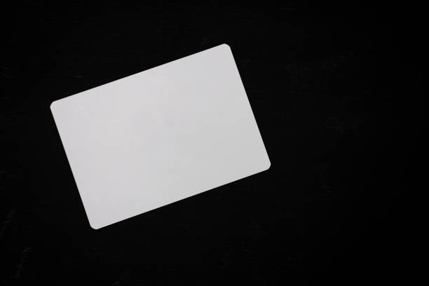 istock White blank paper on a black wooden office desk 1225129625