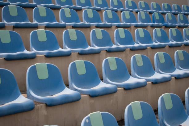 istock empty blue plastic seats in a stadium summer mid day 1225130568