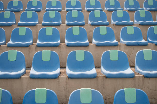 istock empty blue plastic seats in a stadium summer mid day 1225130849