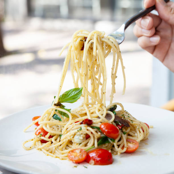istock Spaghetti with anchovy, cherry tomato, onion, chili and pamersan cheese 1225136433