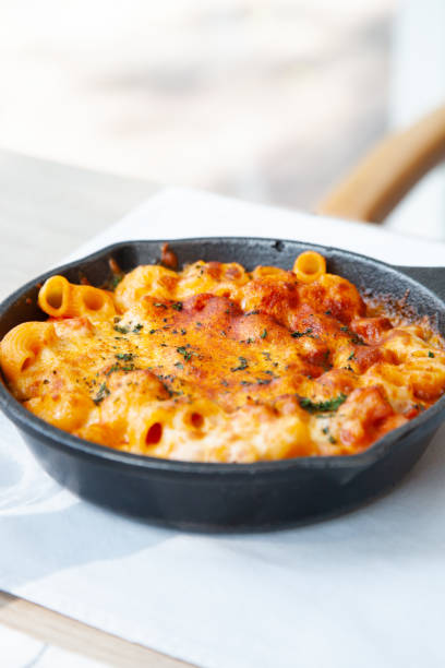 istock Baked macaroni and cheese with fresh tomato sauce 1225137008