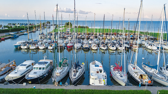 This aerial drone photo shows the harbour of the coastal city named Vlissingen, in Zeeland, the Netherlands. Some boats are in the Port, there is large tower and you can see the North Sea.