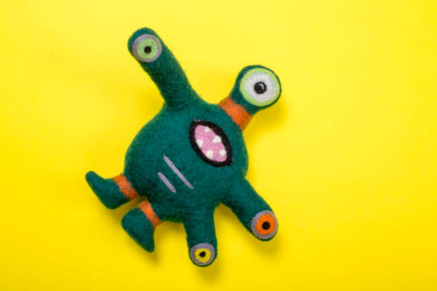 Fantastic creature soft toy made of natural wool on a yellow background