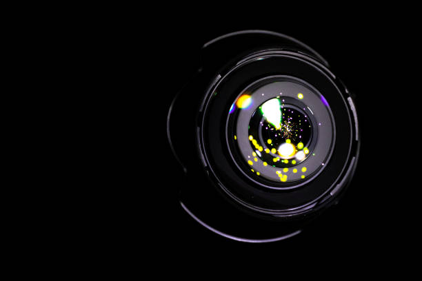 istock Lenses reflection Flare lights on shutter of photo, video camera isolated on black background. Optical ray flash effect in photographer equipment. 1225140119