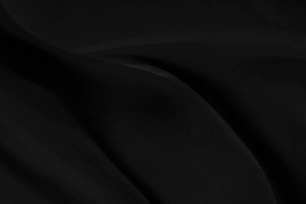 istock Black gray satin dark fabric texture luxurious shiny that is abstract silk cloth background with patterns soft waves blur beautiful. 1225142649
