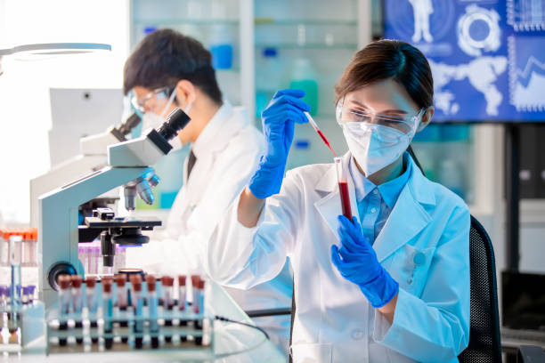 medical worker take test tube microbiologist or medical worker use test tube filling with blood in the laboratoryclose up of microbiologist or medical worker look to blood test result human blood stock pictures, royalty-free photos & images