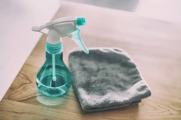 Photo of Surface cleaning home kitchen All purpose cleaner disinfectant spray bottle with towel to clean high touch surfaces from COVID-19 virus contagion