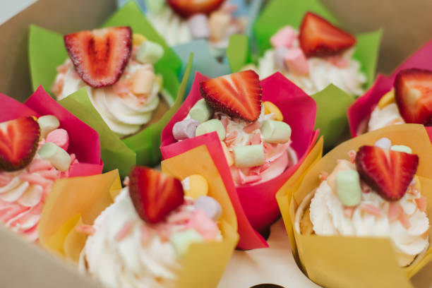 istock sweet cupcakes with strawberries and white cream 1225147400