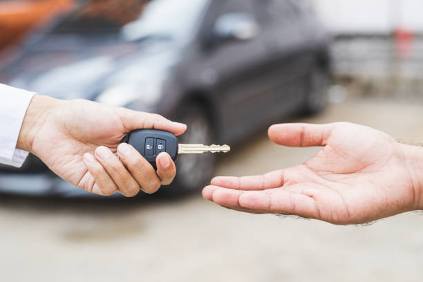 istock Businessman giving a car key. Getting new car. 1225150754
