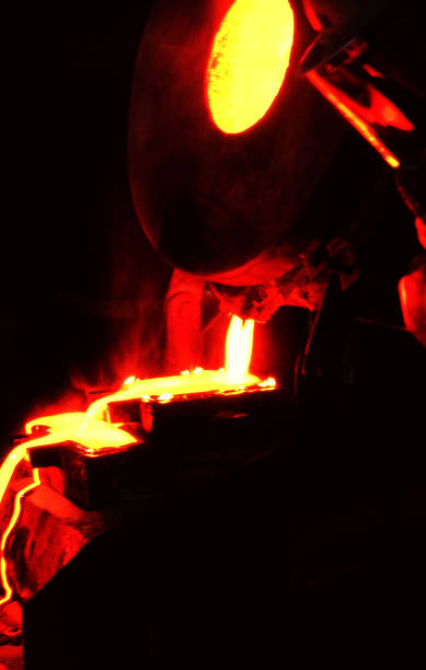 istock Red hot glowing molten Gold being poured into ingot mold 1225154664