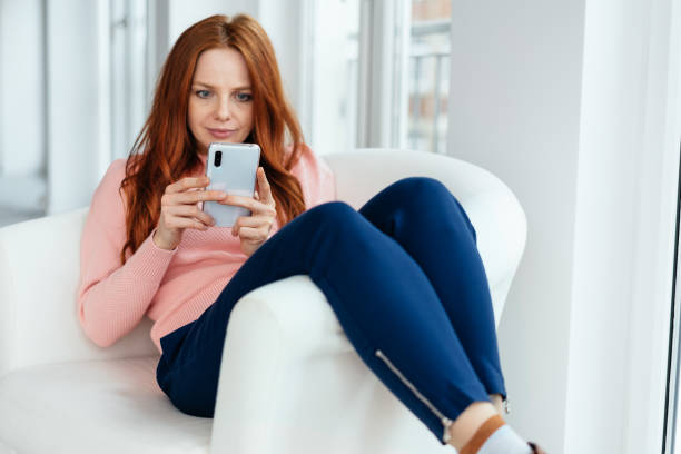istock Engrossed young woman reading a text message 1225154779
