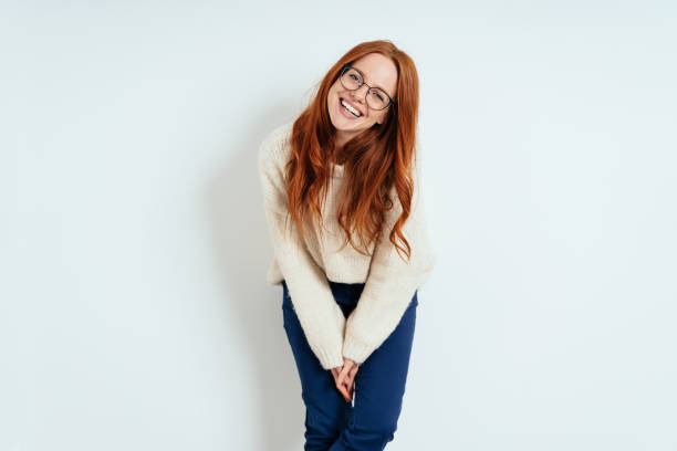 istock Cute young redhead woman looking sweetly at camera 1225155685