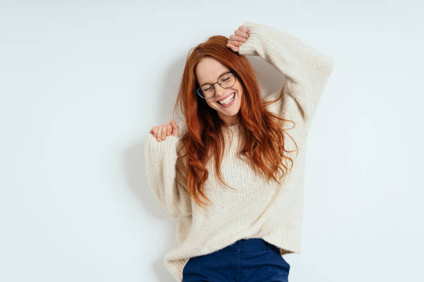 Merry young woman celebrating and dancing