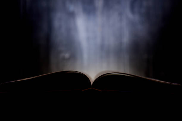 An open book with a glow in the background.