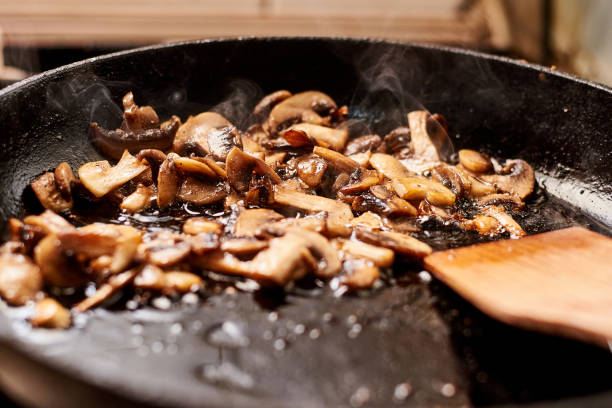 istock Fried mushrooms in a pan. Cooking mushrooms with steam emanating from them. 1225156238