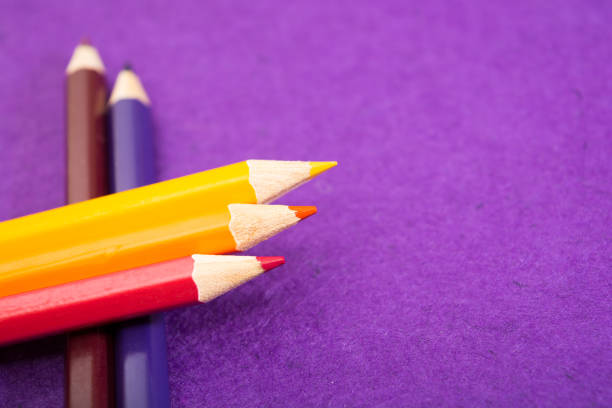 istock Nine multicolored pencils on a purple felt background. Different colored pencils with space for text. Back to school. 1225158261