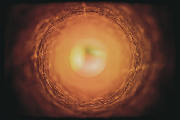 istock Looking through a cardboard tube towards a bright.defocused multi-coloured light 1225158311
