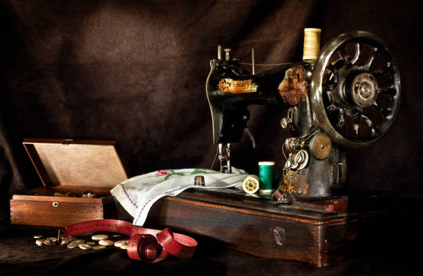 istock Nostalgic Sewing Machine with Fabric and Design Equipments in Dark Scene 1225159522