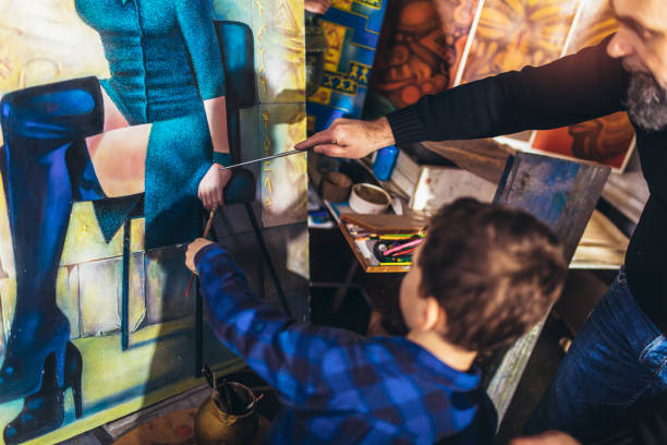 istock Father and son working and painting together in art studio 1225161367